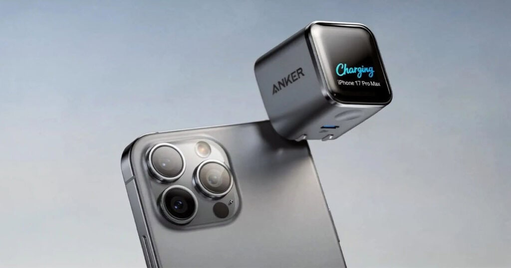 Anker charging cube with a display showing "Charging iPhone 17 Pro Max" floating above the phone's triple-camera module