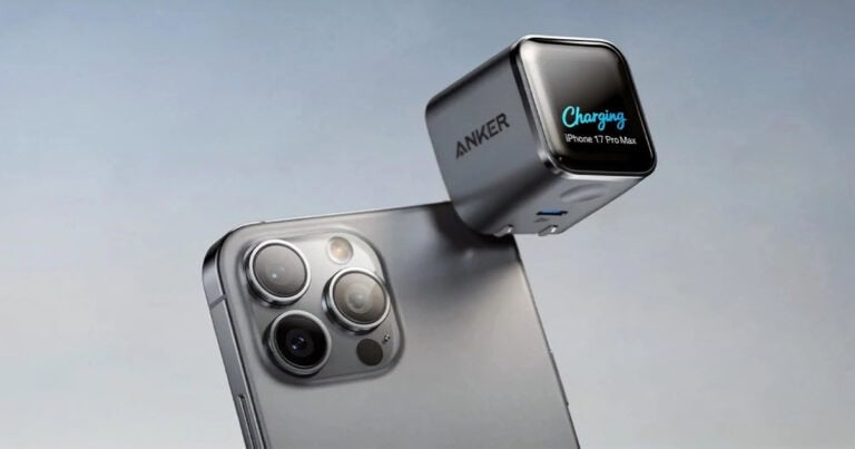 Anker charging cube with a display showing "Charging iPhone 17 Pro Max" floating above the phone's triple-camera module