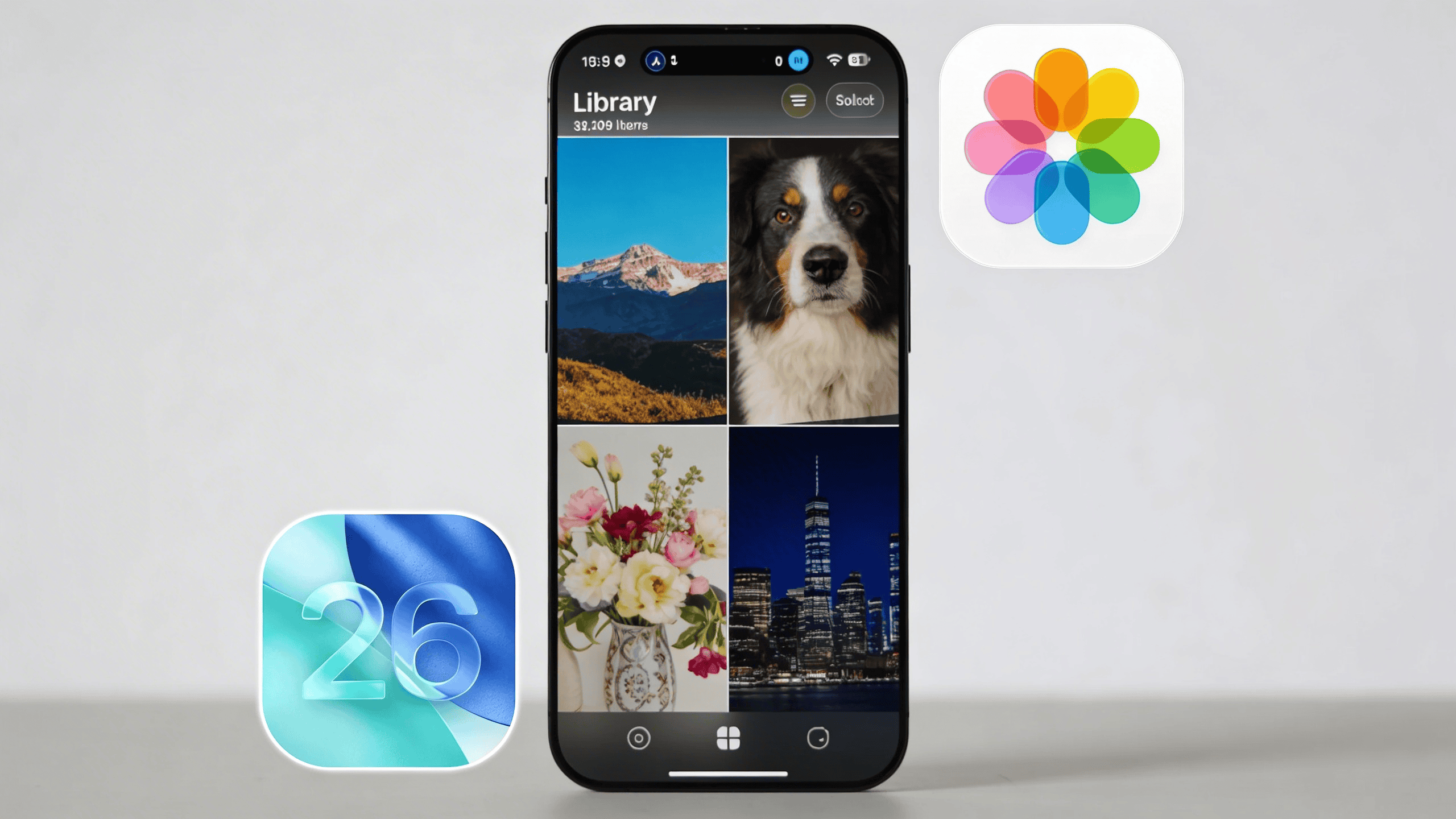 A smartphone displays a redesigned "Library" view within a photo gallery app, showing a grid of four photos: a mountain landscape, a dog portrait, a vase of flowers, and a city skyline at night. To the left of the phone is a translucent "26" icon on a blue background, and to the right is the colorful Apple Photos flower icon.