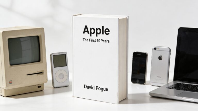 Book titled “Apple: The First 50 Years” surrounded by classic Macintosh, iPod, early iPhone, and MacBook