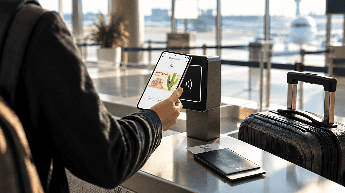 Traveler holding an Android phone near an airport ID reader to present a google wallet state id at security